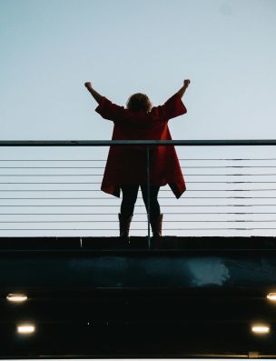 Back View Photo of Standing Woman with Her Hands Raised